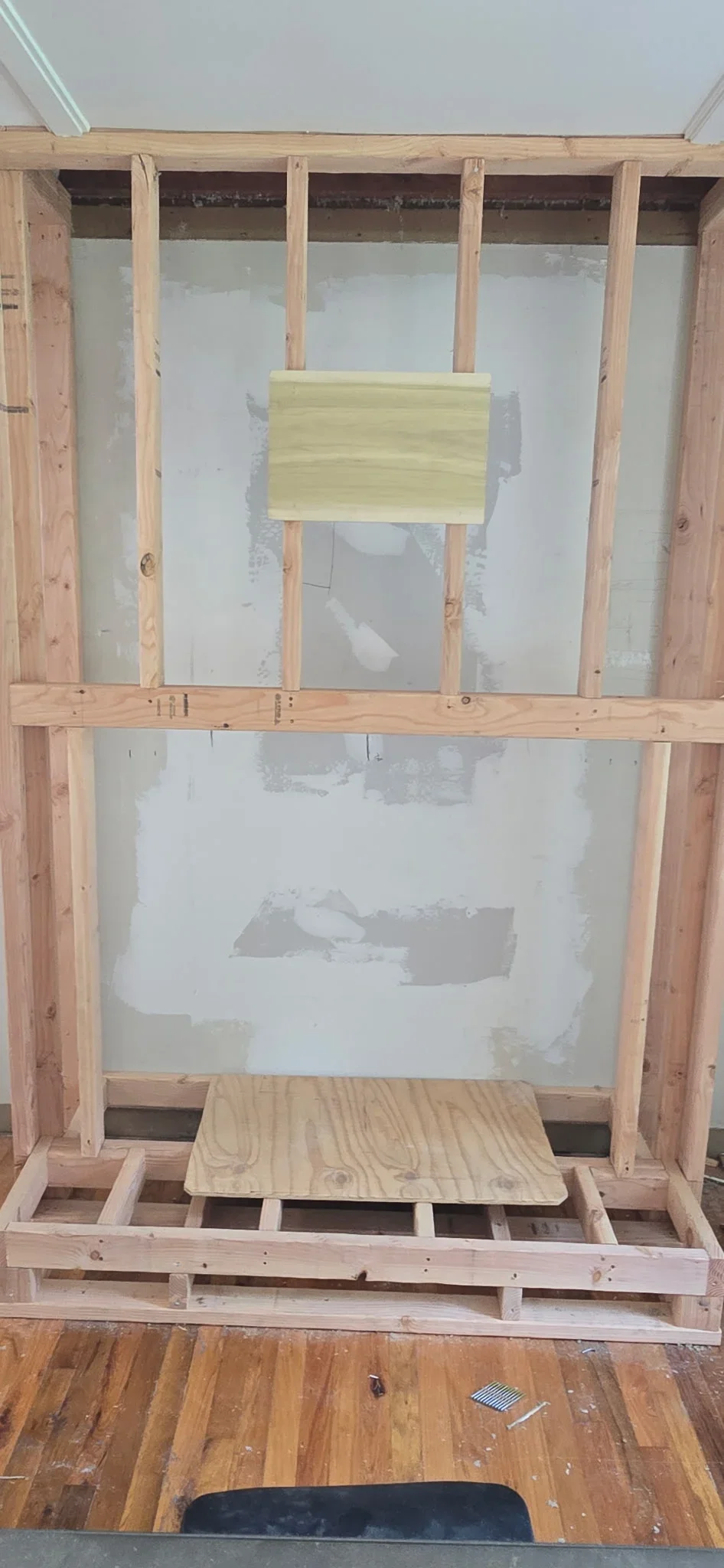 Wood stud framing with drywall installation on kitchen interior wall
