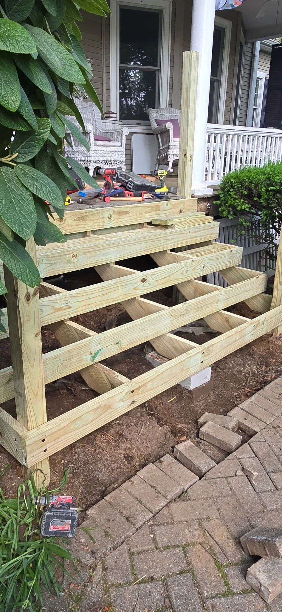 Pressure-treated lumber deck frame with exposed joists and beams during construction